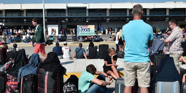 TOPSHOT - Tourists wait outside the terminal building at the airport on the Greek Island of Kos on July 21, 2017 following a 6.5 magnitude earthquake which struck the region.
Two foreigners died and more than 100 people were injured on the Greek island of Kos when an earthquake shook popular Greek and Turkish holiday destinations in the Aegean Sea. The epicentre of the 6.7 magnitude quake was some 10.3 kilometres (6.4 miles) south of the major Turkish resort of Bodrum, a magnet for holidaymakers in the summer, and 16.2 kilometres east of the island of Kos in Greece, the US Geological Survey said. / AFP PHOTO / LOUISA GOULIAMAKI (Photo credit should read LOUISA GOULIAMAKI/AFP/Getty Images)