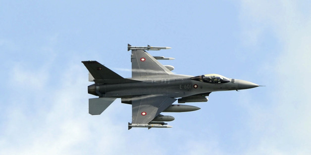 A Danish F-16 Fighting Falcon jet fighter flies over the Sigonella NATO Airbase in the southern Italian island of Sicily March 19, 2011. World powers meeting in Paris on saturday to discuss a coordinated intervention in Libya could launch air strikes as soon as the talks end, a source close to the discussion said. REUTERS/Antonio Parrinello( ITALY - Tags: POLITICS MILITARY)