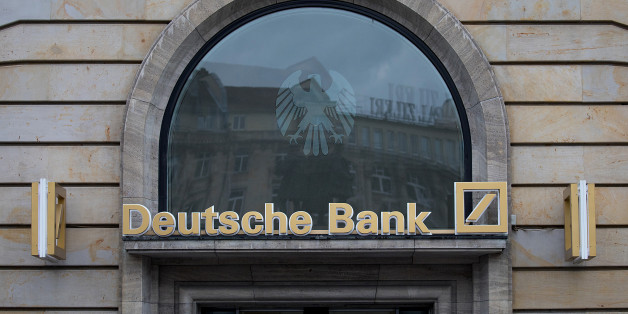 Signage for Deutsche Bank AG sits above a bank branch in Frankfurt, Germany, on Thursday, July 20, 2017. Frankfurt has emerged as a winner of the Brexit vote, with Standard Chartered Plc, Nomura Holdings Inc., Sumitomo Mitsui Financial Group Inc. and Daiwa Securities Group Inc. picking the city as their EU hub in recent weeks. Photographer: Krisztian Bocsi/Bloomberg via Getty Images