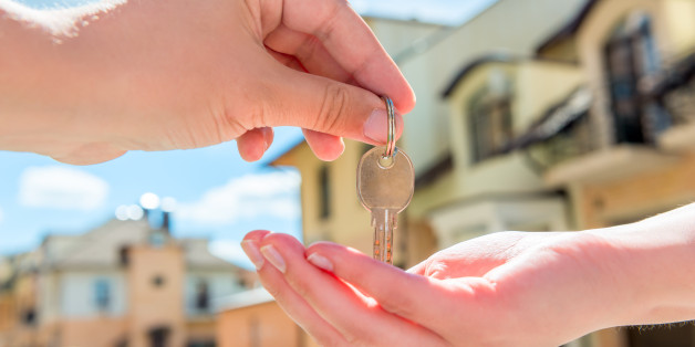 transfer to the buyer of the house key close-up of hands against the sky