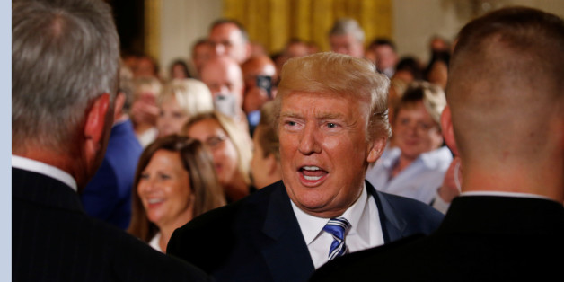 U.S. President Donald Trump greets guests during an event with small businesses in the East Room of the White House in Washington, U.S., August 1, 2017. REUTERS/Jonathan Ernst
