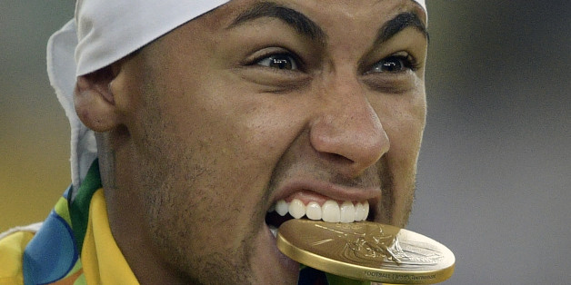 Brazil's forward Neymar poses with medal following the Rio 2016 Olympic Games men's football gold medal match between Brazil and Germany at the Maracana stadium in Rio de Janeiro on August 20, 2016. Neymar struck the winning penalty as Brazil claimed a first ever Olympic football gold medal with victory over Germany at the Maracana on Saturday. / AFP / Juan Mabromata (Photo credit should read JUAN MABROMATA/AFP/Getty Images)