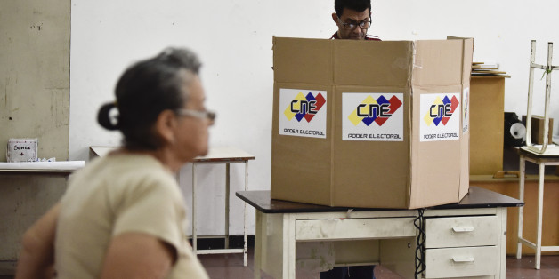 A voter casts a ballot at the Andres Bello High School during the elections for a constituent assembly in downtown Caracas, Venezuela, on Sunday, July 30, 2017. This vote, which was convened by President Nicolas Maduro, is the first step in a potential overhaul of the country's constitution which threatens to upend six decades of democracy in the oil-producing nation. Photographer: Carlos Becerra/Bloomberg via Getty Images