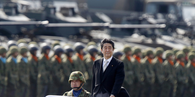 ASAKA, JAPAN - OCTOBER 23: Japanese Prime Minister Shinzo Abe, center right, inspects troops of the Self Defense Forces during the annual review at the Japan Ground Self-Defense Force Camp Asaka on October 23, 2016 in Asaka, Japan. (Photo by Tomohiro Ohsumi/Getty Images)