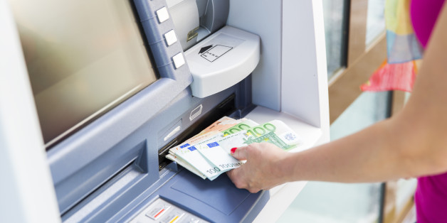 Young woman is Getting cash from ATM..mixed euro bills