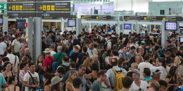 Passengers gather as they wait for passing the security controls at Barcelona's El Prat airport due to a strike of security agents on August 4, 2017, in Barcelona.As the tourism season in Barcelona is at its peak, security agents at the popular Mediterranean city's El Prat airport will go on strike from today in what could considerably lengthen queues for visitors. / AFP PHOTO / Josep LAGO (Photo credit should read JOSEP LAGO/AFP/Getty Images)