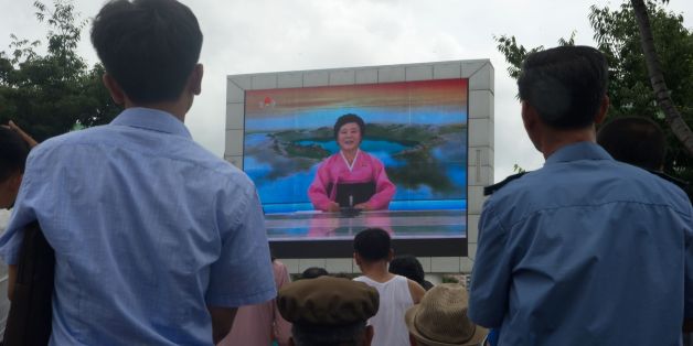 People watch as coverage relating to an ICBM missile test is displayed on a screen in a public square in Pyongyang on July 29, 2017.
Kim Jong-Un boasted of North Korea's ability to strike any target in the US after a second ICBM test that weapons experts said on July 29 could even bring New York into range - in a potent challenge to President Donald Trump. / AFP PHOTO / Kim Won-Jin (Photo credit should read KIM WON-JIN/AFP/Getty Images)