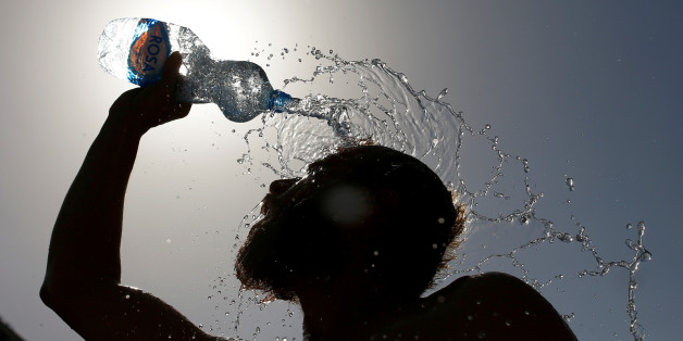 A man pours water on his face to cool off from hot weather in Skopje, Macedonia July 24, 2017. REUTERS/Ognen Teofilovski TPX IMAGES OF THE DAY