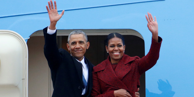 Former president Barack Obama waves with his wife Michelle as they board Special Air Mission 28000, a Boeing 747 which serves as Air Force One, at Joint Base Andrews, Maryland, U.S. January 20, 2017. REUTERS/Brendan McDermid