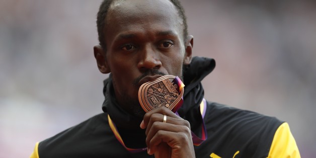 Athletics - World Athletics Championships â menâs 100 metres victory ceremony â London Stadium, London, Britain â August 6, 2017 â Usain Bolt of Jamaica (Bronze) poses with the medal. REUTERS/Matthew Childs