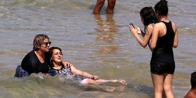 Algerian women wear a "burkini" in the sea at the beach of Oran, West of Algiers on 5 August 2017. (Photo by Billal Bensalem/NurPhoto via Getty Images)