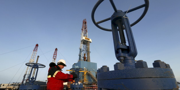 A worker checks an oil pipe at the Lukoil-owned Imilorskoye oil field outside the West Siberian city of Kogalym, Russia, in this January 25, 2016 file photo. REUTERS/Sergei Karpukhin