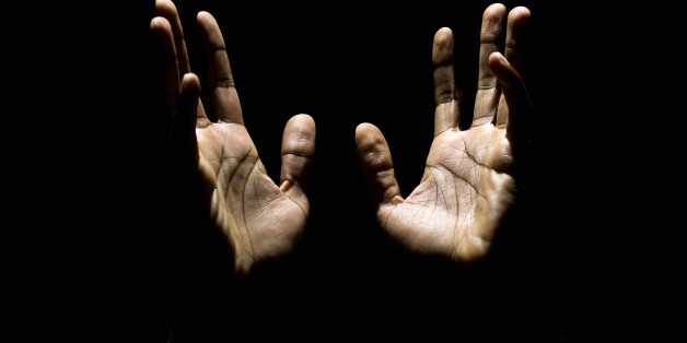 african american male hands raised to heaven in a pray (this picture has been taken with a Hasselblad H3D II 31 megapixels camera)