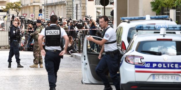 Journalists (back) gather behind a cordon as police work at the site where a car slammed into soldiers in Levallois-Perret, outside Paris, on August 9, 2017.French police launched a manhunt on August 9 after a car rammed into soldiers near their barracks outside Paris, injuring six people, two of them seriously. The incident took place at about 8:00 am (0600 GMT) outside a military barracks in the northwestern Paris suburb of Levallois-Perret. / AFP PHOTO / STEPHANE DE SAKUTIN (Photo cred