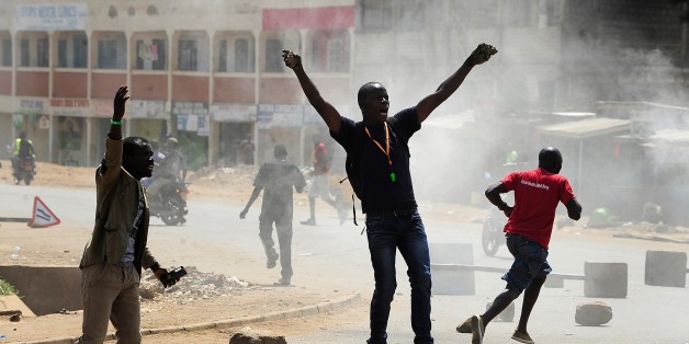 Supporters of Kenya's National Super Alliance (NASA) shout slogans as they set fire to barricades in Kisumu on August 9, 2017, as they protest after the announcement of national election results.President Uhuru Kenyatta appeared headed for re-election but his rival Raila Odinga claimed a massive hacking attack had manipulated results, ratcheting up tensions in opposition strongholds. Police engaged in running battles with a few hundred protesters in Odinga's bastion Kisumu in western Kenya, firi