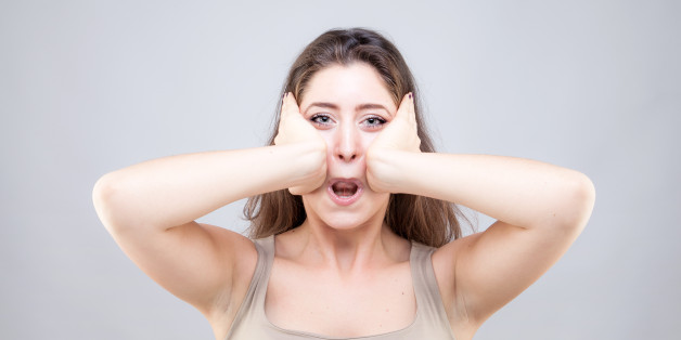 Beautiful young caucasian woman doing face yoga pose
