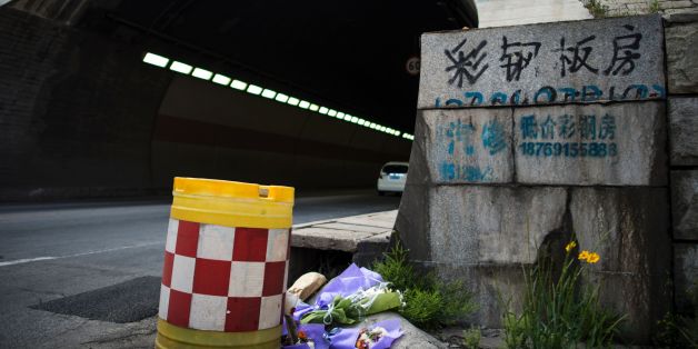 Flowers are placed at the entrance of the Taojiakuang tunnel in the city of Weihai in Shandong province on May 10, 2017.
Eleven South Korean and Chinese kindergarteners and their driver were killed when a school bus crashed and burst into flames in a tunnel in eastern China on May 9, officials said. / AFP PHOTO / Johannes EISELE (Photo credit should read JOHANNES EISELE/AFP/Getty Images)