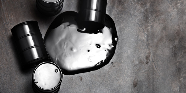 High angle view on four fuel drums with spilled oil