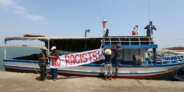 Tunisian fishermen hang banners as they gather on August 6, 2017 in the port of Zarzis in southeastern Tunisia to protest against a possible berthing of the C-Star vessel, hired by far-right activists from a group which calls itself 'Generation Identity' to prevent would-be migrants from reaching Europe.On August 4, the Tunisian Forum for Economic and Social Rights (FTDES) said it was opposed to the C-Star 'docking in Tunisian ports' and called on the government not to cooperate with its racist