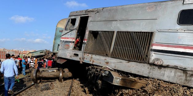 People gather at the site of a train collision in the area of Khorshid, in Egypts Mediterranean city of Alexandria, on August 11, 2017.
At least 36 people were killed as two trains collided outside of Alexandria, in one of the deadliest in a string of such accidents in Egypt, the health ministry said. / AFP PHOTO (Photo credit should read /AFP/Getty Images)