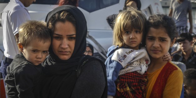 CANAKKALE, TURKEY - AUGUST 08: A group of refugees from Syria, Eritrea, Afghanistan and Congo are seen after they were captured by coast guard while they were trying to pass illegally to Lesbos of Greece from Ayvacik's Babakale village in Canakkale, Turkey on August 08, 2017. Turkish coast guard captured 51 refugees during the operation and brought them to the coast guard police station at Kucukkuyu town.
(Photo by Hanife Erdinc/Anadolu Agency/Getty Images)