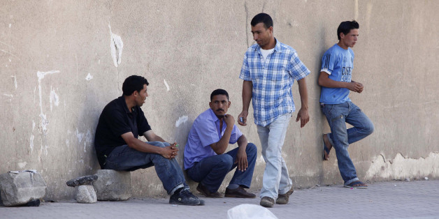 Men wait for casual work offers on a street of Cheraga, west of Algiers, June 24, 2010. Local officials say that Islamist insurgents, fighting a lingering conflict with Algeria's security forces, are targeting small armies of unemployed young men and persuading some of them to join their ranks across Algeria. To match Feature SECURITY-QAEDA/ALGERIA REUTERS/Louafi Larbi (ALGERIA - Tags: CIVIL UNREST POLITICS)