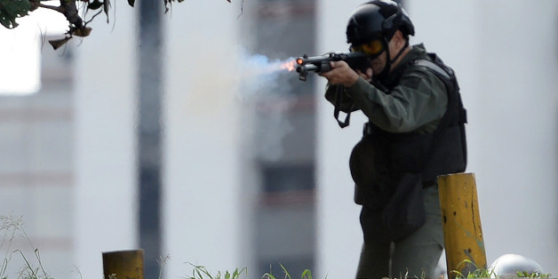 TOPSHOT - A police confronts opposition activists during a demonstration marking 100 days of protests against Venezuelan President Nicolas Maduro in Caracas, on July 9, 2017.
Venezuela hit its 100th day of anti-government protests on Sunday, one day after its most prominent political prisoner, Leopoldo Lopez, vowed to continue his fight for freedom after being released from jail and placed under house arrest. At least 91 people have died since non-stop street protests began on April 1. / AFP PHOTO / Federico PARRA (Photo credit should read FEDERICO PARRA/AFP/Getty Images)