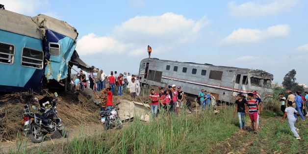 People gather at the site of a train collision in the area of Khorshid, in Egypt's Mediterranean city of Alexandria, on August 11, 2017.
At least 36 people were killed as two trains collided outside of Alexandria, in one of the deadliest in a string of such accidents in Egypt, the health ministry said. / AFP PHOTO / STR (Photo credit should read STR/AFP/Getty Images)