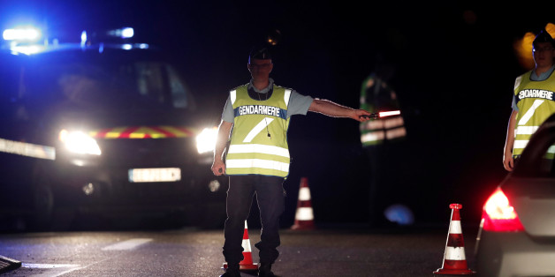 French gendarmes maintain a roadblock a certain distance from the scene where a car ploughed into the outdoor terrace of a pizzeria, killing a young girl and injuring several other people according to media reports in Sept-Sorts, east of Paris, France, August 14, 2017. REUTERS/Benoit Tessier