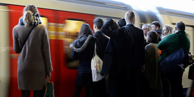 Commuters wait on the platform as a tube arrives on the London Underground, Britain November 16, 2016. REUTERS/Kevin Coombs