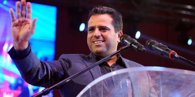 Tunisian founder and president of the Free Patriotic Union, Slim Riahi greets his supporters during a campaign meeting in the Mellassine city, a poor neighborhood of Tunis on October 24, 2014. Tunisians vote on October 26, 2014 to elect their first parliament since the country's 2011 revolution, in a rare glimmer of hope for a region torn apart by post-Arab Spring violence and repression. AFP PHOTO / FETHI BELAID (Photo credit should read FETHI BELAID/AFP/Getty Images)
