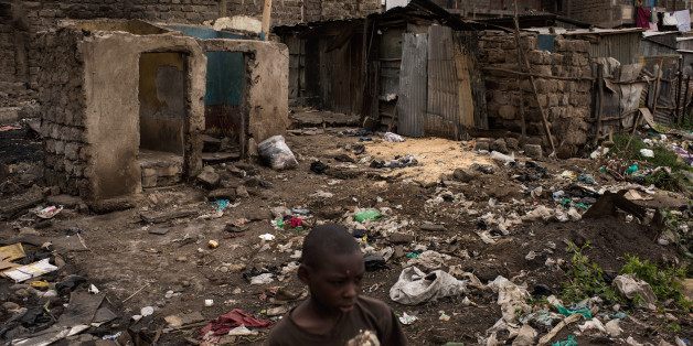 NAIROBI, KENYA - AUGUST 14: A boy walks through homes that were burned in unrest two days prior in the Mathare North neighborhood on August 14, 2017 in Nairobi, Kenya. Nairobi remained peaceful, but tensions remain high as oppositions supporters wait to hear from candidate Raila Odinga who has rejected the results that named Uhuru Kenyatta to his second term in Kenya's 2017 presidential election. (Photo by Andrew Renneisen/Getty Images)