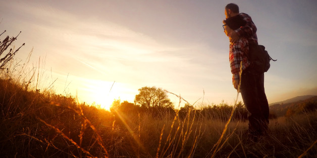 Father and son enjoying the sunset