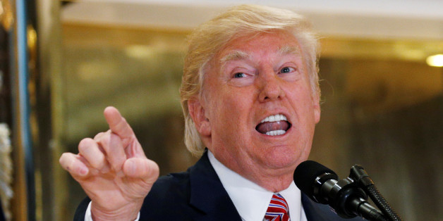 U.S. President Donald Trump answers questions about his response to the violence, injuries and deaths at the "Unite the Right" rally in Charlottesville as he talks to the media in the lobby of Trump Tower in Manhattan, New York, U.S., August 15, 2017. REUTERS/Kevin Lamarque