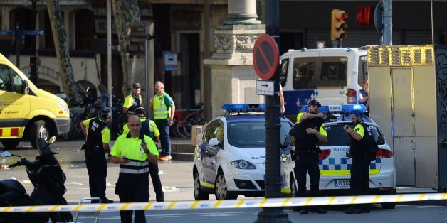 Medical staff members and policemen stand in a cordoned off area after a van ploughed into the crowd, injuring several persons on the Rambla in Barcelona on August 17, 2017.
Police in Barcelona said they were dealing with a 'terrorist attack' after a vehicle ploughed into a crowd of pedestrians on the city's famous Las Ramblas boulevard on August 17, 2017. Police were clearing the area after the incident, which has left a number of people injured. / AFP PHOTO / Josep LAGO (Photo credit should read JOSEP LAGO/AFP/Getty Images)
