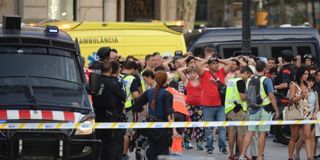 Policemen check the identity of people standing with their hands up after a van ploughed into the crowd, killing two persons and injuring several others on the Rambla in Barcelona on August 17, 2017.
A driver deliberately rammed a van into a crowd on Barcelona's most popular street on August 17, 2017 killing at least two people before fleeing to a nearby bar, police said.
Officers in Spain's second-largest city said the ramming on Las Ramblas was a 'terrorist attack' and a police source said one suspect had left the scene and was 'holed up in a bar'. The police source said they were hunting for a total of two suspects. / AFP PHOTO / Josep LAGO (Photo credit should read JOSEP LAGO/AFP/Getty Images)