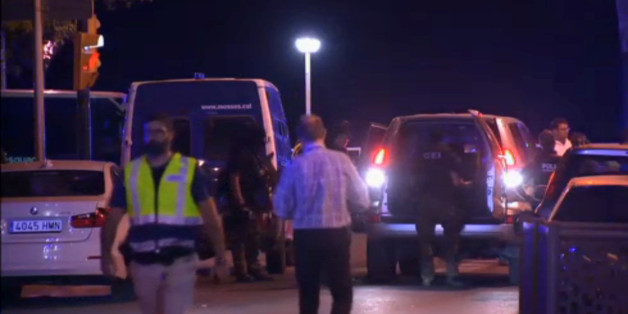 Officers investigate at the scene where police had killed four attackers in Cambrils, south of Barcelona, in this still image taken from Reuters video on August 18, 2017. REUTERS TV via REUTERS