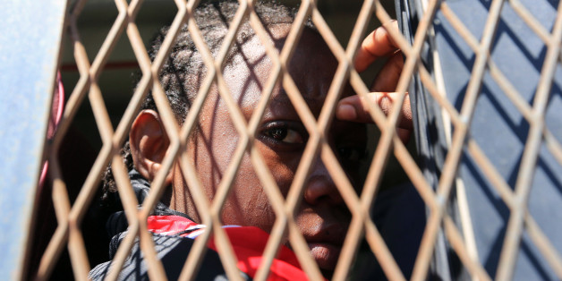 African Migrants gather at a the Illegal Immigration Authority in Tripoli on August 17, 2017 ahead of being repatriated to their country of origin under a voluntary program coordinated by the International Organization for Migration (IOM). / AFP PHOTO / MAHMUD TURKIA (Photo credit should read MAHMUD TURKIA/AFP/Getty Images)