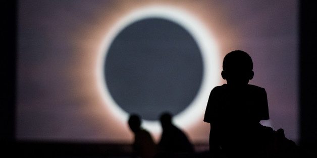 COLUMBIA, SC - AUGUST 20: Children watch a presentation about the eclipse during a drive-in movie at the Historic Columbia Speedway August 20, 2017 in Columbia, South Carolina. Columbia is one of the prime destinations for viewing Monday's solar eclipse and NASA expects clear weather would bring over a million visitors to the state. (Photo by Sean Rayford/Getty Images)