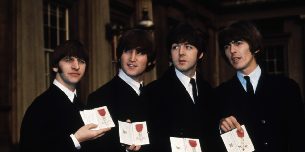 The Beatles (l to r) Ringo Starr, John Lennon, Paul McCartney, and George Harrison show off their MBE medals after their investiture at Buckingham Palace. (Photo by © Hulton-Deutsch Collection/CORBIS/Corbis via Getty Images)