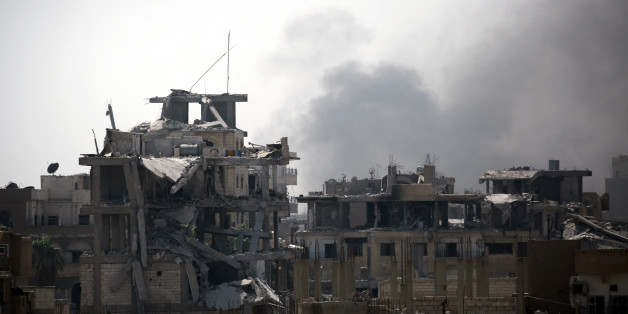 Smoke billows in an eastern area of the embattled northern Syrian city of Raqa on August 15, 2017, as Syrian Democratic Forces (SDF), a US backed Kurdish-Arab alliance, battle to retake the city from the Islamic State (IS) group. / AFP PHOTO / DELIL SOULEIMAN (Photo credit should read DELIL SOULEIMAN/AFP/Getty Images)