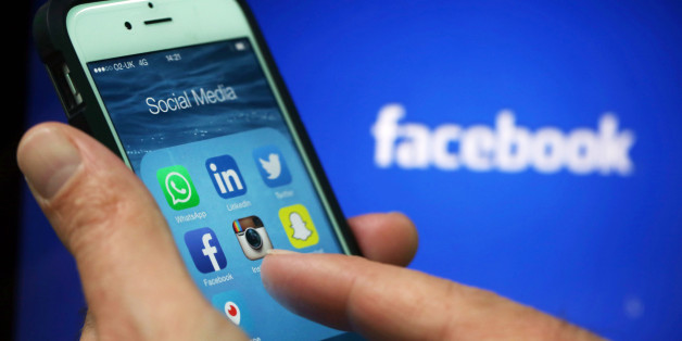 Social media apps including WhattsApp, LinkedIn, Twitter, FaceBook, Instagram, SnapChat and Periscope are displayed in a social media folder on the screen of an Apple Inc. iPhone 6 in this arranged photograph taken in London, U.K., on Friday, May, 15, 2015. Facebook Inc. reached a deal with New York Times Co. and eight other media outlets to post stories directly to the social network's mobile news feeds, as publishers strive for new ways to expand their reach. Photographer: Chris Ratcliffe/Bloo