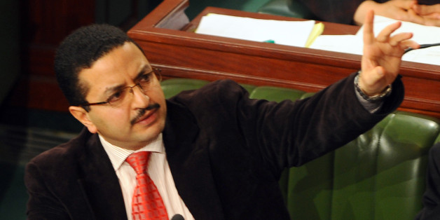 Tunisian Islamist MP and General Rapporteur of the constitution, Khedher Habib (L) gestures to talk during a session at the National Constituent Assembly (NCA) as part of the debates on a new constitution on January 17, 2014, in Tunis. The assembly is pushing ahead with the adoption of a long-delayed new constitution, voting article by article, but failed to complete the task by an agreed deadline of January 14, the third anniversary of Ben Ali's downfall. AFP PHOTO / FETHI BELAID (Photo