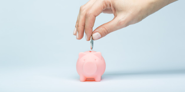 Female hand putting a coin into piggy bank. Light blue background, soft shadow. Canon 5D MK III