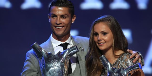 Real Madrid's Portuguese forward Cristiano Ronaldo (L) poses the trophy after he was awarded the title of 'Best Men's Player in Europe' while standing alongside ' Best Womans player in Europe' Netherlands Lieke Martens at the conclusion of the UEFA Champions League group stage draw ceremony in Monaco on August 24, 2017. / AFP PHOTO / VALERY HACHE (Photo credit should read VALERY HACHE/AFP/Getty Images)