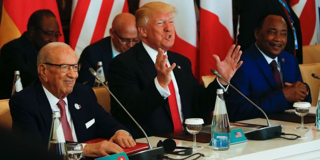 U.S. President Donald Trump gestures next to Tunisia's President Beji Caid Essebsi (L) and Nigers President Mahamadou Issoufou (R) at the G7 Summit expanded session, on May 27, 2017 in Taormina, Sicily. / AFP PHOTO / POOL / JONATHAN ERNST (Photo credit should read JONATHAN ERNST/AFP/Getty Images)