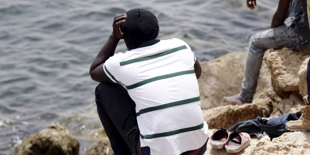 A migrant looks out to the sea as he rests outside a temporary detention centre after being rescued by Tunisian authorities in Ben Guerdane, Tunisia, June 16, 2015. The migrants belong to a group of more than 350 illegal migrants who were rescued by Tunisia's navy on June 10. REUTERS/Anis Mili