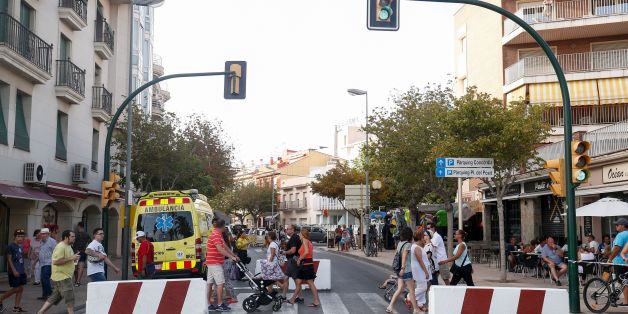 People walk past concrete barriers displayed to avoid vehicles to go through before a protest against terrorism in Cambrils following Barcelona and Cambrils attacks on August 25, 2017, one week after a van ploughed into the crowd, killing 13 persons and injuring over 100.
Drivers have ploughed on August 17, 2017 into pedestrians in two quick-succession, separate attacks in Barcelona and another popular Spanish seaside city, leaving 14 people dead and injuring more than 100 others. In the first incident, which was claimed by the Islamic State group, a white van sped into a street packed full of tourists in central Barcelona on Thursday afternoon, knocking people out of the way and killing 13 in a scene of chaos and horror. Some eight hours later in Cambrils, a city 120 kilometres south of Barcelona, an Audi A3 car rammed into pedestrians, injuring six civilians -- one of them critical -- and a police officer, authorities said. / AFP PHOTO / PAU BARRENA (Photo credit should read PAU BARRENA/AFP/Getty Images)