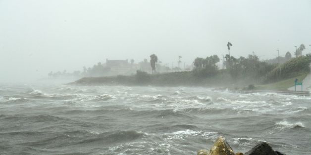 Strong winds batter seaside houses before the approaching Hurricane Harvey in Corpus Christi, Texas on August 25, 2017.
Hurricane Harvey will soon hit the Texas coast with forecasters saying it's possible for up to 3 feet of rain and 125 mph winds. / AFP PHOTO / MARK RALSTON (Photo credit should read MARK RALSTON/AFP/Getty Images)
