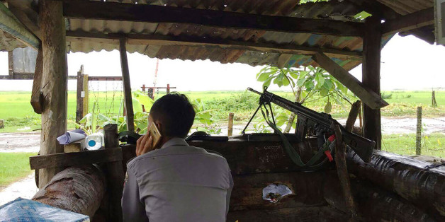 A Myanmar policeman talks on the phone as he mans a check point at the entrance of Yathae Taung township in Rakhine State in Myanmar on August 26, 2017.
At least 89 people including a dozen security forces were killed as Rohingya militants besieged border posts in northern Rakhine State which is bisected by religious hatred focused on the stateless Rohingya Muslim minority, who are reviled and perceived as illegal immigrants in Buddhist-majority Myanmar. / AFP PHOTO / STR (Photo credit should read STR/AFP/Getty Images)